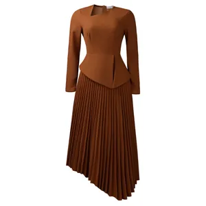 Detail of asymmetrical pleated hem and irregular neckline on elegant brown dress
