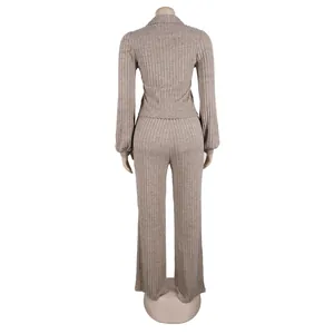 Detailed back view of an elegant ribbed knit two-piece set featuring lantern sleeves in beige