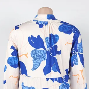 Close-up of the elegant blue floral print pattern on this cream short V-neck dress
