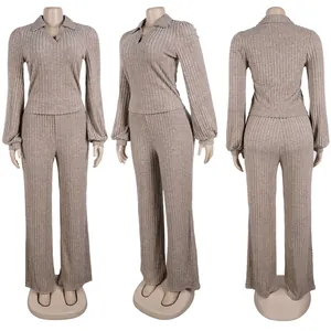 Detail of elegant ribbed two-piece set with lantern sleeve top and matching pants.