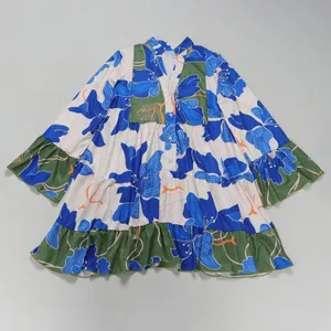 Elegant short loose V-neck dress with large blue floral print and green ruffle details