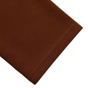 Close-up of double-stitched hem on a dark brown elegant dress fabric