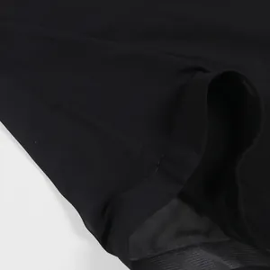 Primer plano del tejido de gasa negra de un elegante vestido capa suelto con costuras.