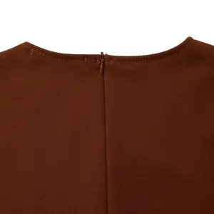 Detailed macro view of the invisible zipper and fine neckline stitching on brown dress