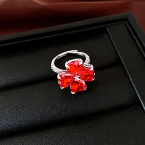 Gedetailleerde opname van een zilveren ring met vier rode hartvormige zirkonia's