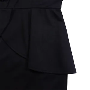 Close-up of the elegant layered ruffle detail on a stylish black long-sleeve dress.