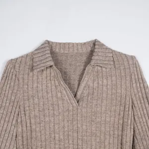 Close-up detail of a beige ribbed knit polo collar sweater with a soft texture
