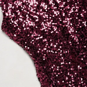 Detailed macro view of shimmering wine red sequins on elegant mesh fabric dress