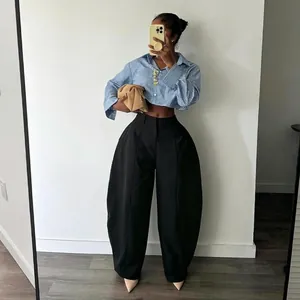 Elegant high-waisted black balloon trousers with an avant-garde voluminous silhouette