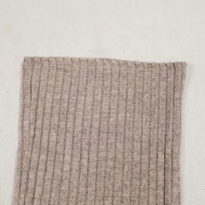 Detailed macro view of high-quality soft beige ribbed knit fabric showing texture