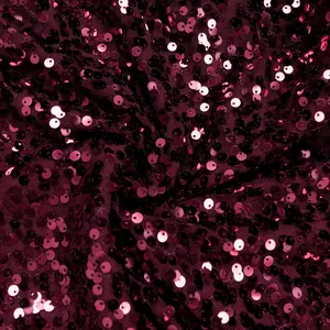 Macro shot of high-density wine red sequins on mesh fabric for elegant evening wear