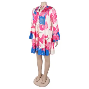 Detail view of an elegant V-neck floral print dress with vibrant pink and blue pattern.
