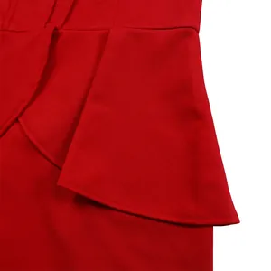 Close-up detail showing the elegant ruffle peplum design of this red long-sleeve dress