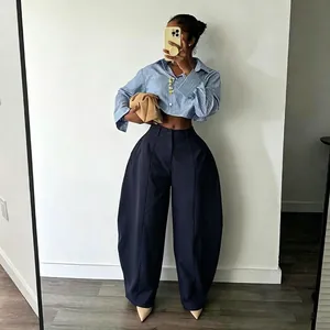 High-fashion navy wide-leg trousers with unique bulbous silhouette and pleated detail.