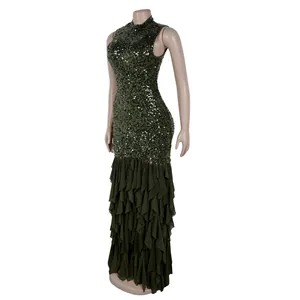 Detailed view of the dark green sequined top and tiered mesh ruffled skirt of the gown