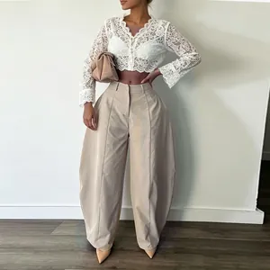 Full view of women's high-waist khaki wide-leg trousers and white lace crop top.