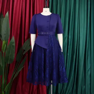 Detail view of a navy plus-size faux two-piece dress with lace patchwork and high waist.