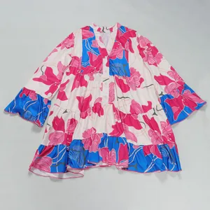 Detail view of an elegant loose floral print mini dress with V-neck and color-block style.