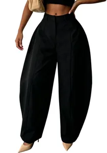 Detail view of high-waisted black wide-leg trousers with a loose silhouette design