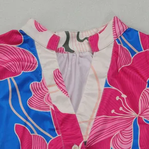 Close-up of elegant floral print V-neckline detail on a contrast color mini dress.