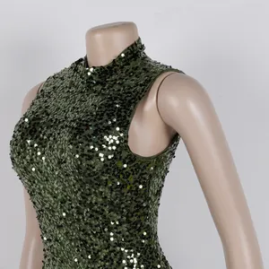 Macro detail of elegant dark green sequin patchwork dress featuring a high neckline design