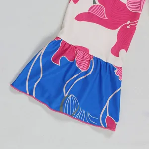 Close-up view of the elegant floral print and flared sleeve on this contrast color dress