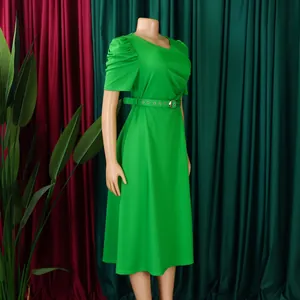 Detail of green V-neck pleated midi dress with short puffed sleeves and belt