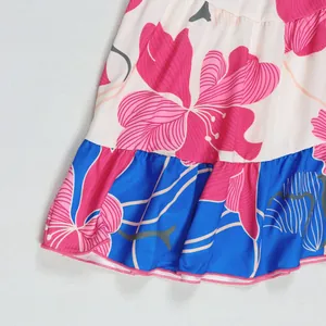 Detailed view of pink floral print and blue ruffled hem on contrast short dress