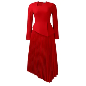 Detailed view of the red asymmetric neck and pleated hem of the elegant midi dress.