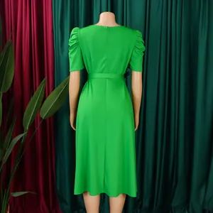 Back view of elegant green midi dress with puff sleeves and belted waist details