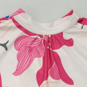Close-up of elegant floral print and neckline detail on a color-block short dress.