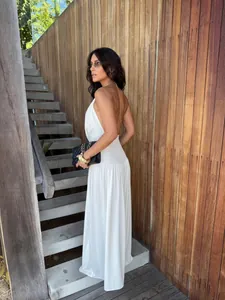 Elegant white halter neck backless pleated wide-leg two-piece set worn by model