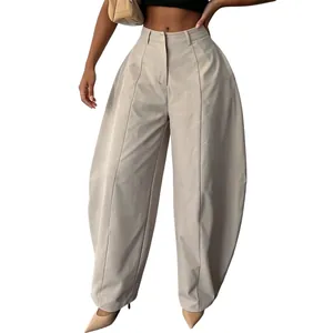 Detailed view of high-waisted wide-leg trousers with elegant pleats and a loose fit