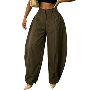 Detailed view of oversized dark brown balloon trousers with a wide-leg silhouette