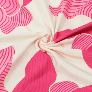 Close-up detail of the vibrant pink floral printed fabric with soft draped texture