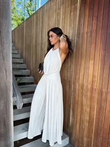 Detailed view of white pleated wide-leg set showing the fluid drape and texture