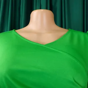 Detailed close-up showing the elegant V-neckline of a vibrant green summer pleated dress