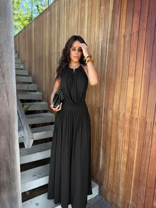 Full body view showing the elegant fit and draping of the black halter pleated set