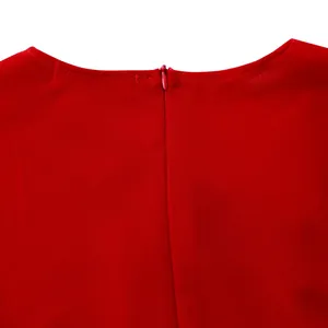 Close-up detail showing the hidden back zipper and clean neckline of an elegant red dress.