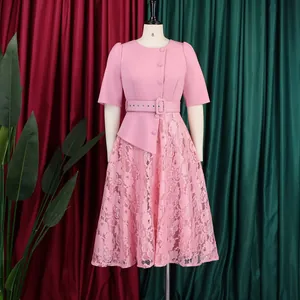 Pink lace patchwork mock two-piece dress with belt detail on mannequin.