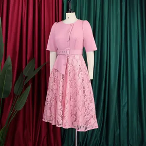 Detailed view of an elegant pink lace patchwork dress with a belted waist design