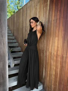 Elegant black halter neck pleated wide-leg two-piece set worn by a model in detail