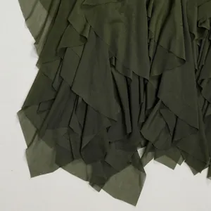 Detail of olive green tiered mesh fabric showing fine net texture and layered ruffles.