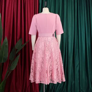 Detailed back view of an elegant pink dress with lace patchwork and high waist belt