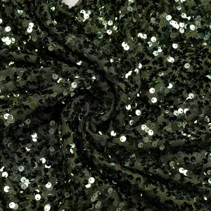 Detailed macro view of dark green mesh fabric featuring dense, shimmering sequins.