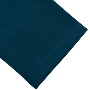 Close-up macro detail of double-needle stitching on elegant teal blue midi dress sleeve