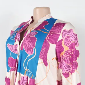 Detailed view of elegant floral print V-neck dress with blue color-blocking pattern.