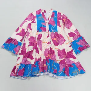 Detailed flat lay view of a loose elegant floral V-neck dress with blue contrast panels