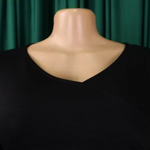 Close-up detail of a classic black V-neckline on an elegant pleated summer dress