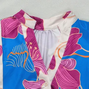 Detailed close-up view of the elegant floral print V-neckline on this stylish contrast dress